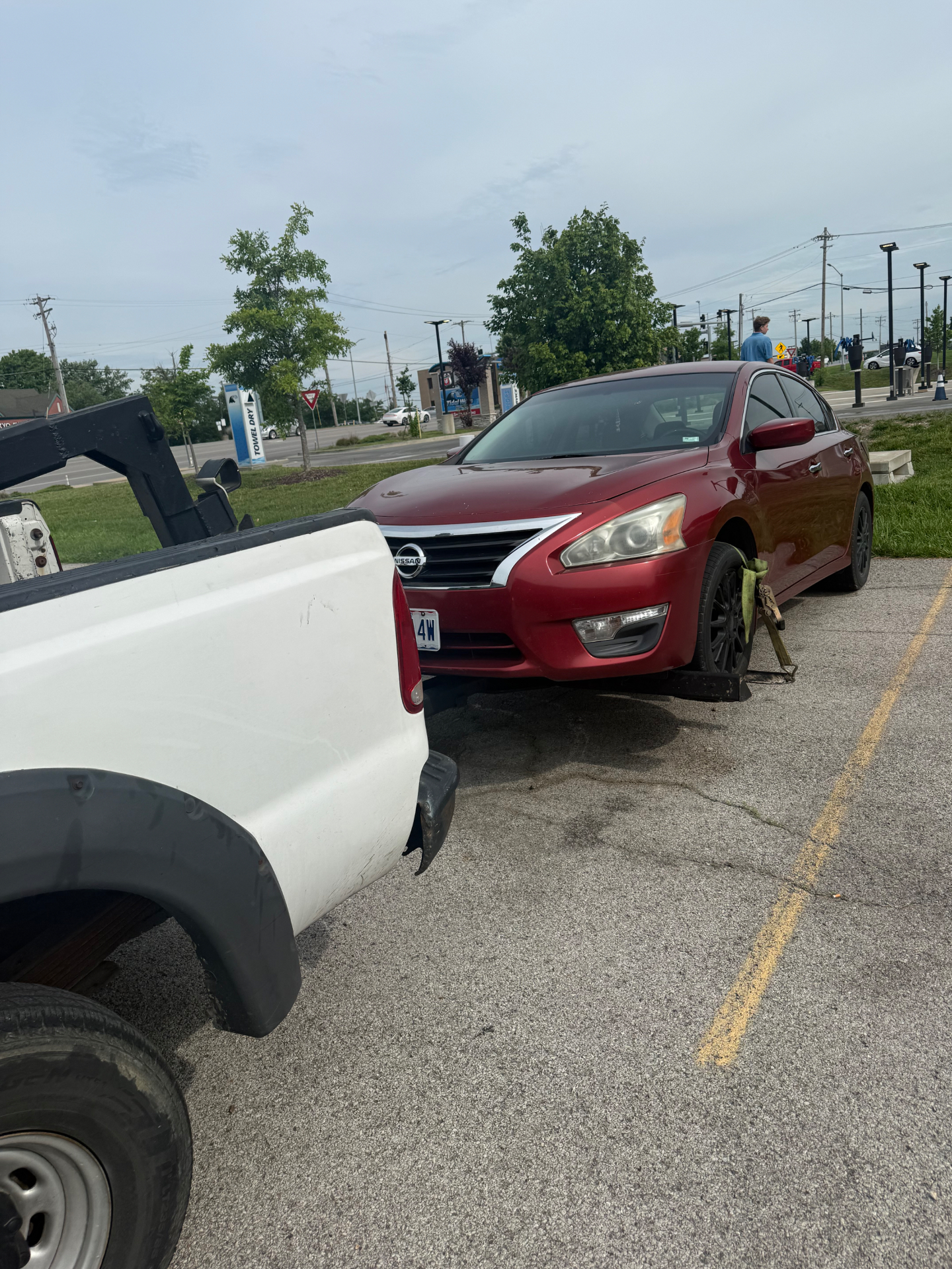 Get Right Towing loading a red sedan for junk car pickup in St. Louis
