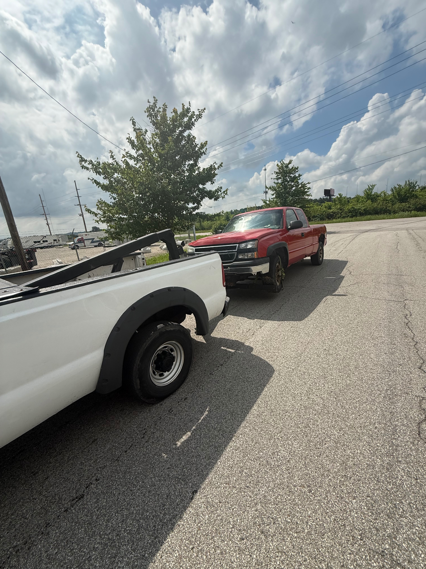 Get Right Towing towing a red pickup truck for vehicle removal